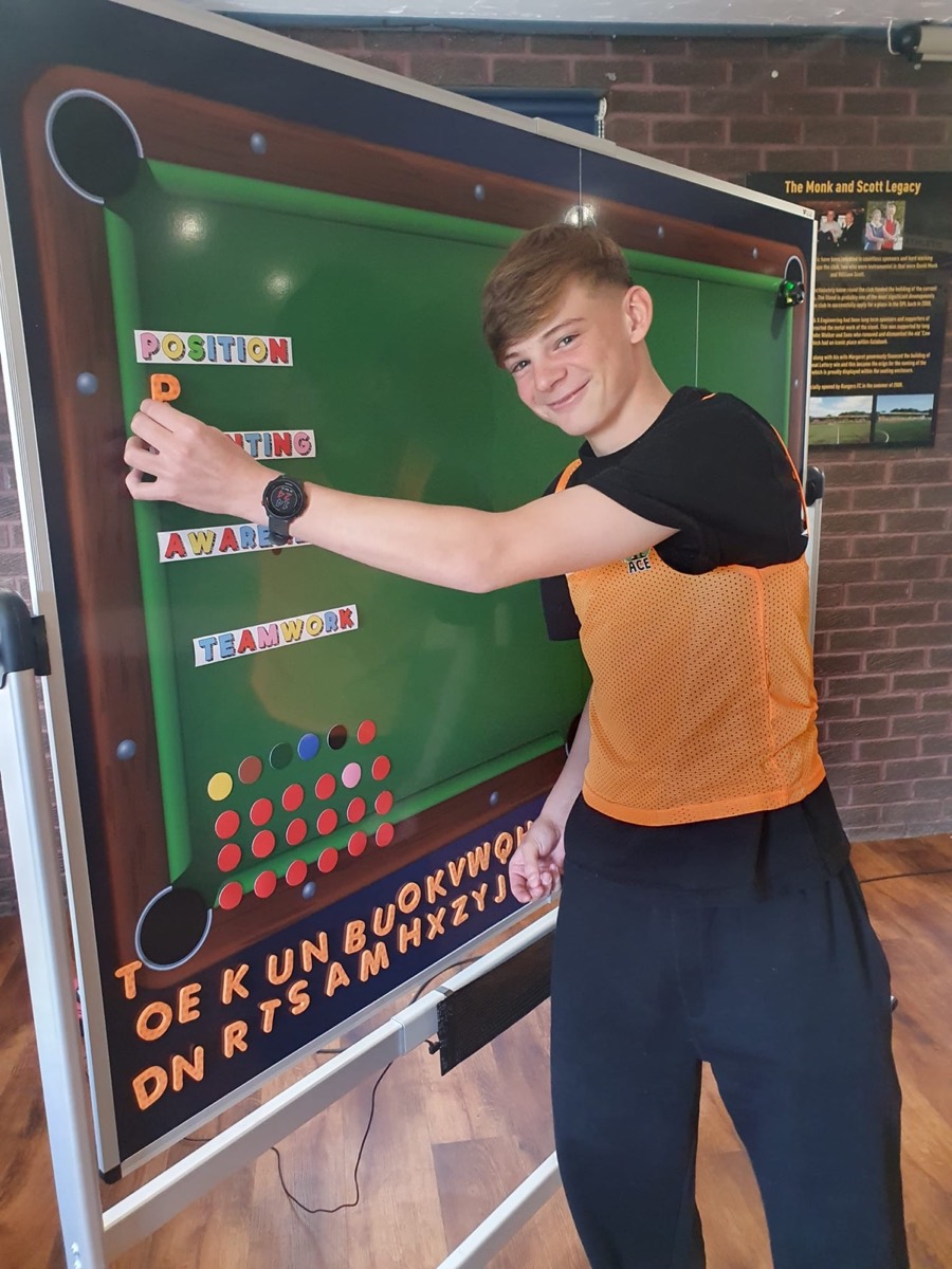 A junior placing words on the ACE snooker learning board