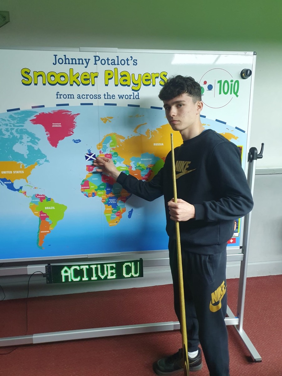 A junior pointing to Scotland on the snooker players world map
